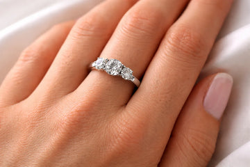 Past present future engagement ring with three diamonds in platinum setting