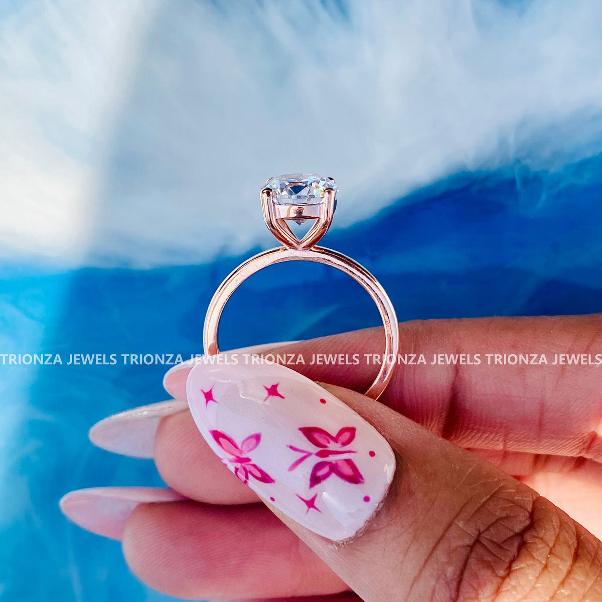 Close-up of the 4-prong setting securing the round cut moissanite stone in gold