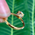 Woman wearing the round moissanite solitaire ring, close-up on her hand