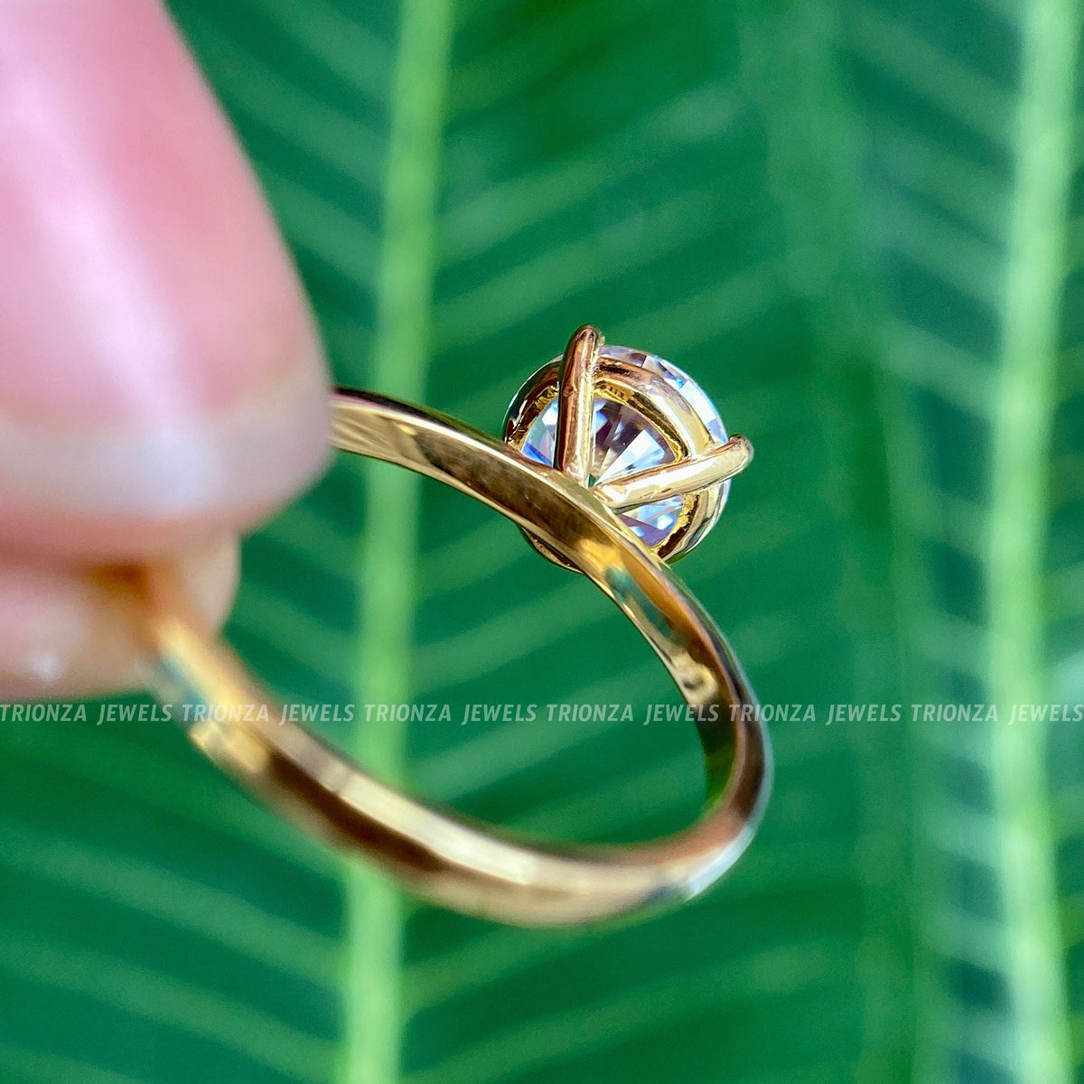 Woman wearing the round moissanite solitaire ring, close-up on her hand