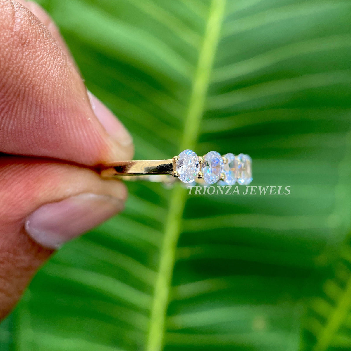 Handmade oval eternity ring displayed inside its jewelry box with smooth fabric