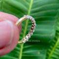 Side view of the oval cut moissanite band highlighting its excellent polish and symmetry