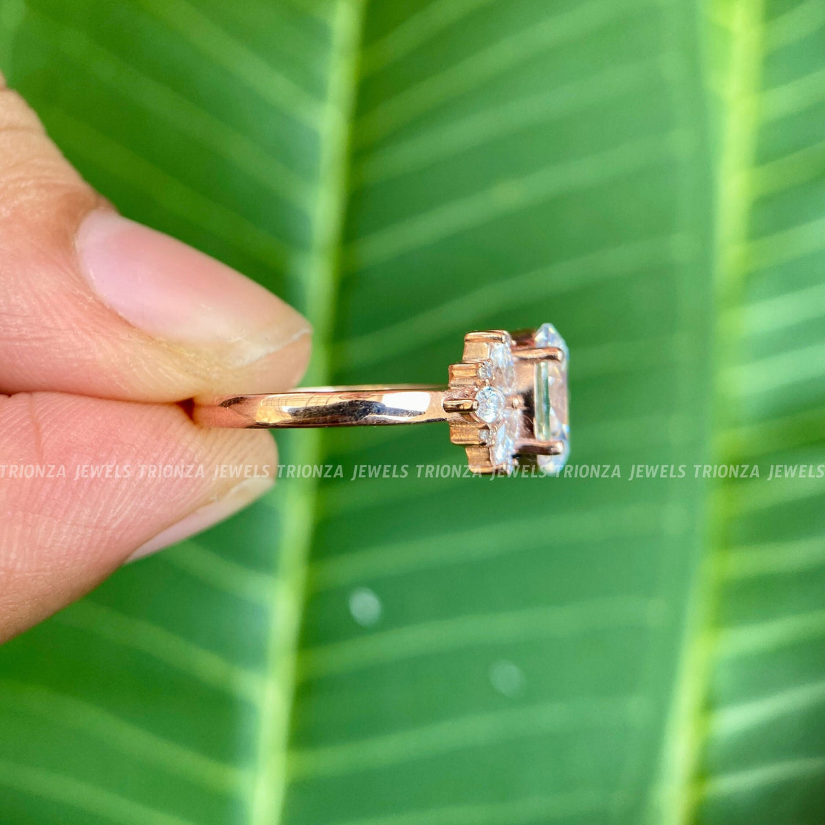 Side profile of the prong set oval moissanite ring highlighting its vintage cluster design