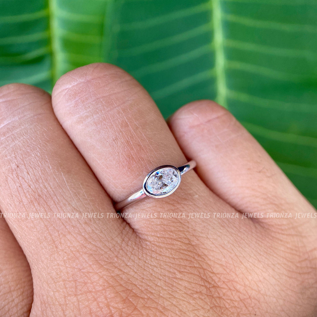 Oval moissanite engagement ring in 14K Solid Gold with a bezel setting for a modern look