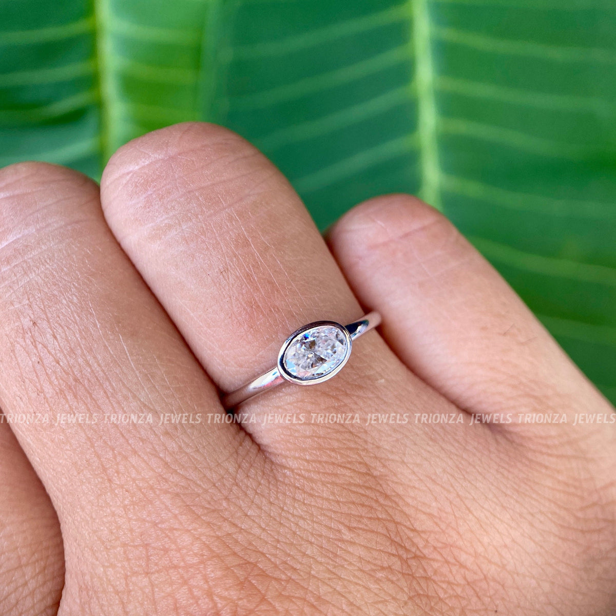 Close-up of the 0.50 ct oval cut moissanite showing its colorless VVS clarity