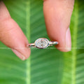 Woman wearing the oval moissanite promise ring, close-up on her hand