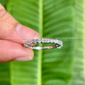 Close-up of the baguette and round moissanite stones set along the yellow gold band