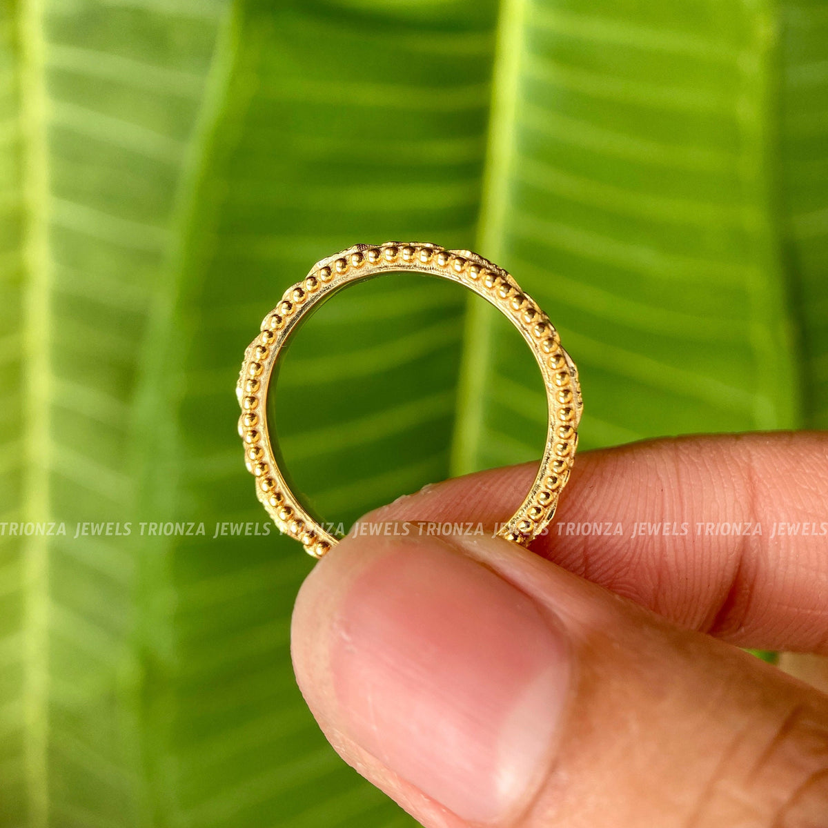 Close-up of the 2.5 mm eternity band highlighting the floral design pattern