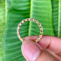 Close-up of the 2.50mm round moissanite stones set in a minimalist stackable band