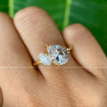 Close-up of the 1.25 CT pear cut moissanite set beside a 0.34 CT pear side stone