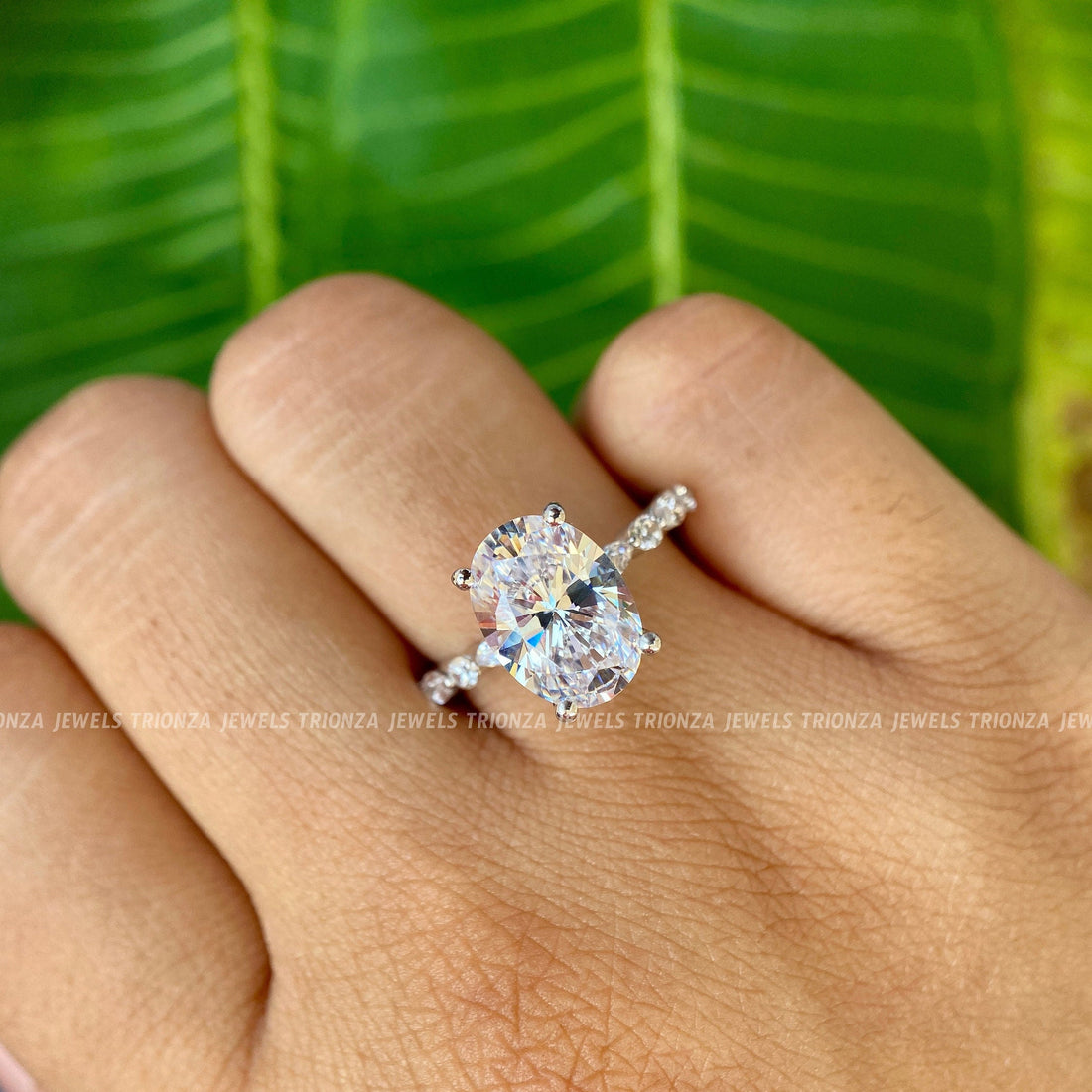 Oval moissanite engagement ring with an antique elongated cut and open gap solitaire design