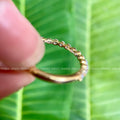 Personalized moissanite wedding band displayed in a jewelry box with smooth fabric