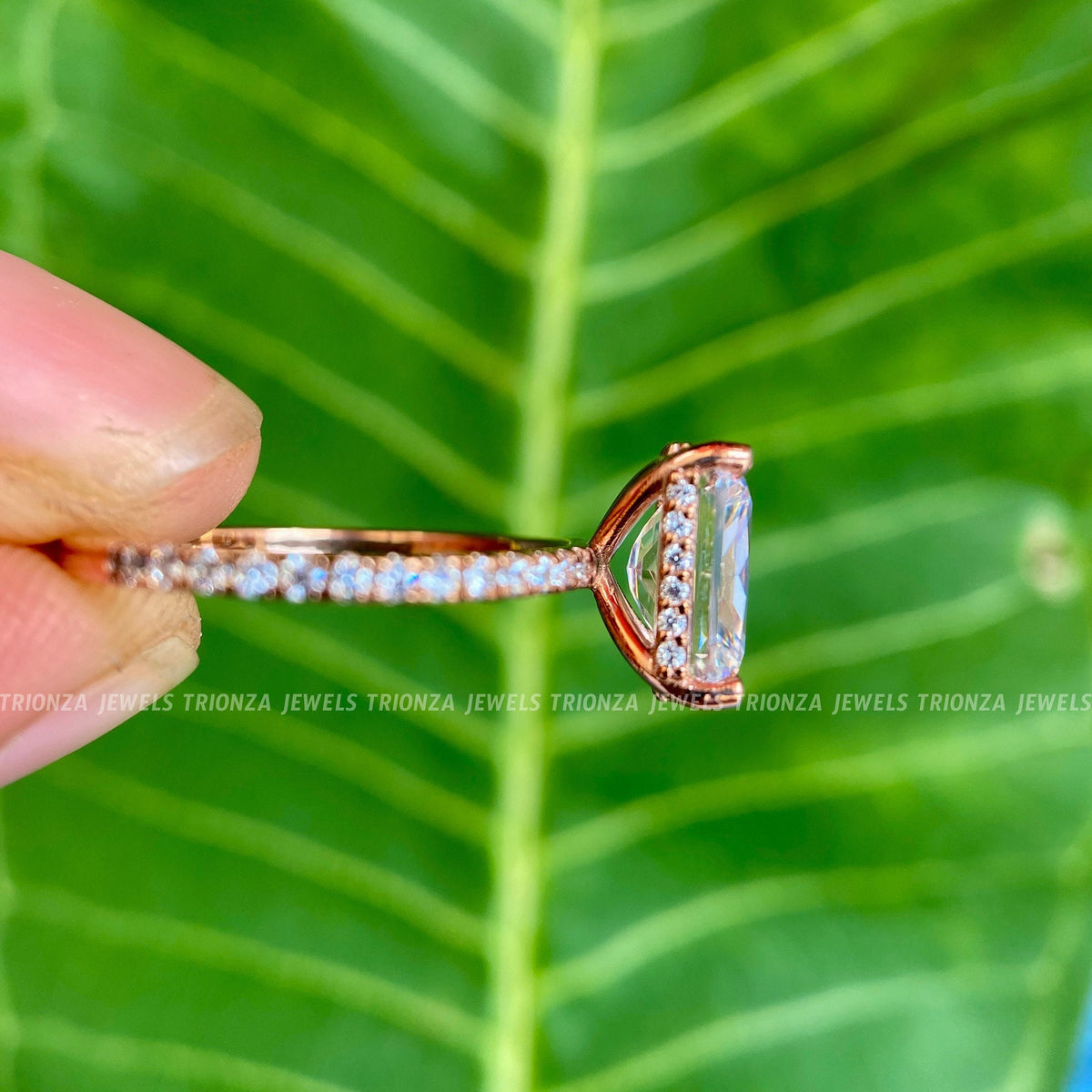 Close-up of the prong set halo showcasing round moissanite stones around the radiant center stone