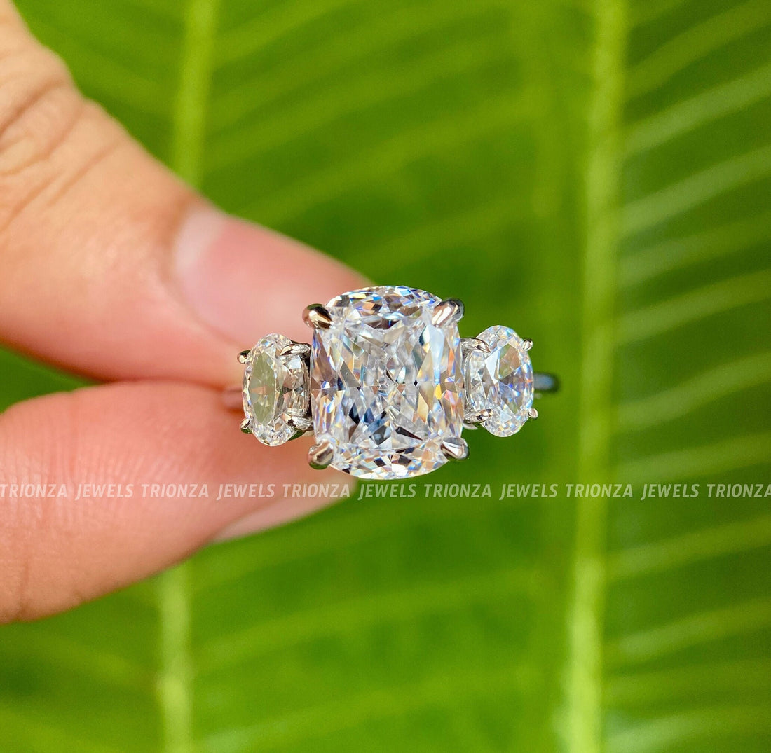 Cushion cut moissanite engagement ring with oval three stone accents set in 14K gold
