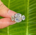 Cushion cut moissanite engagement ring with oval three stone accents set in 14K gold