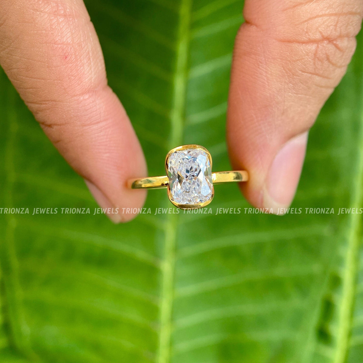 Woman wearing the cushion cut moissanite engagement ring on her hand
