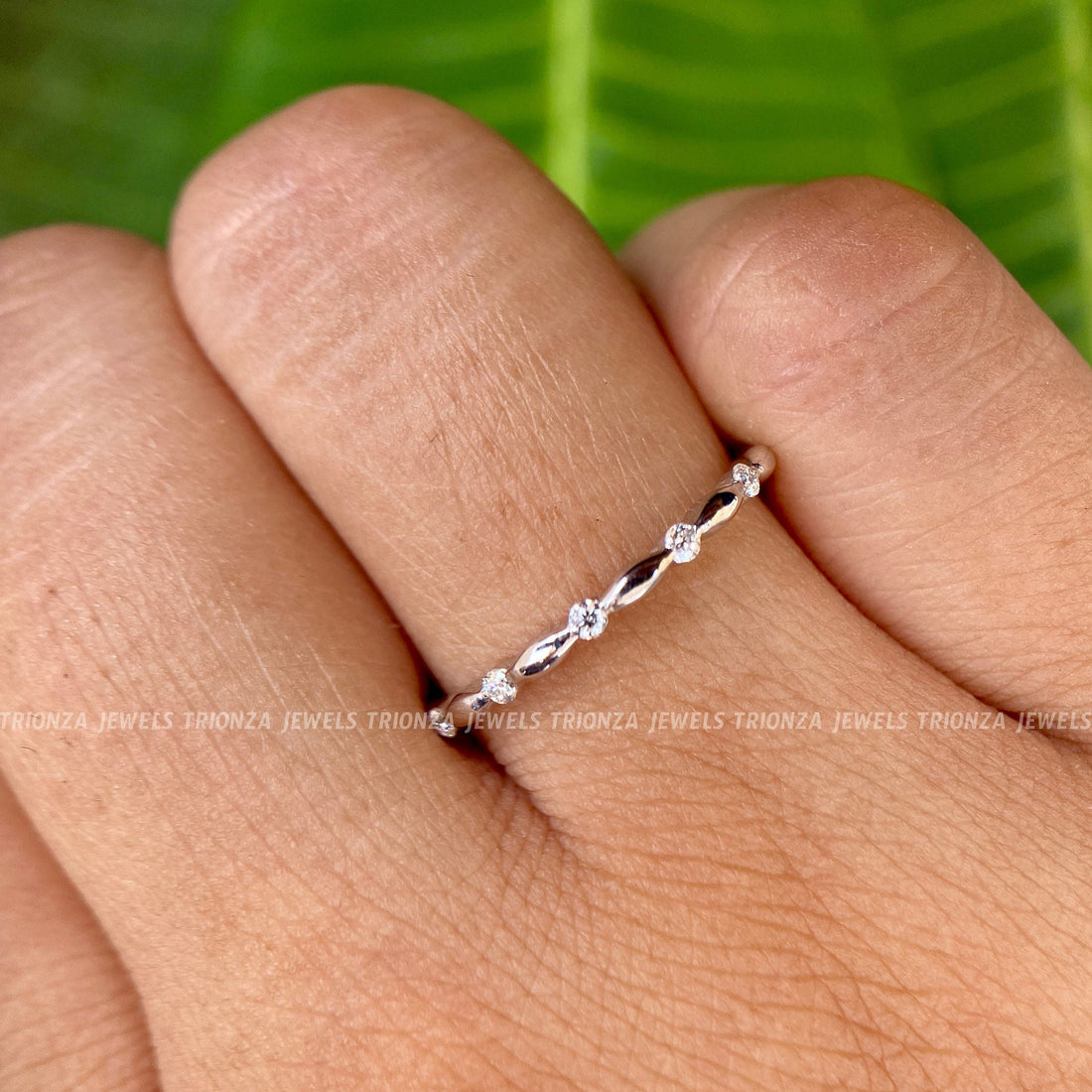 Alternating marquise and round cut moissanite half eternity band displayed up close