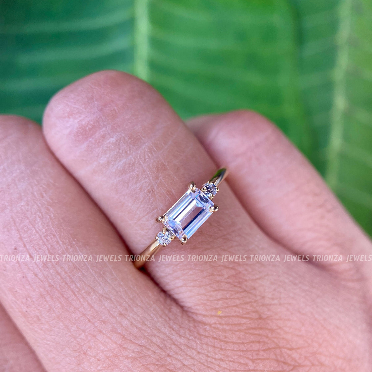 Emerald cut moissanite engagement ring displayed in 14K solid gold with a solitaire setting