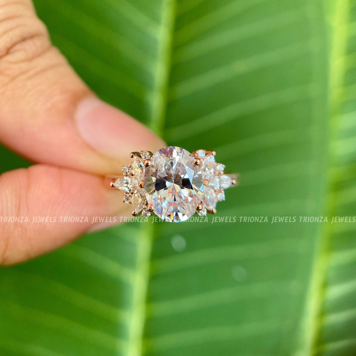 Woman wearing the oval moissanite engagement ring, displayed close-up on her hand