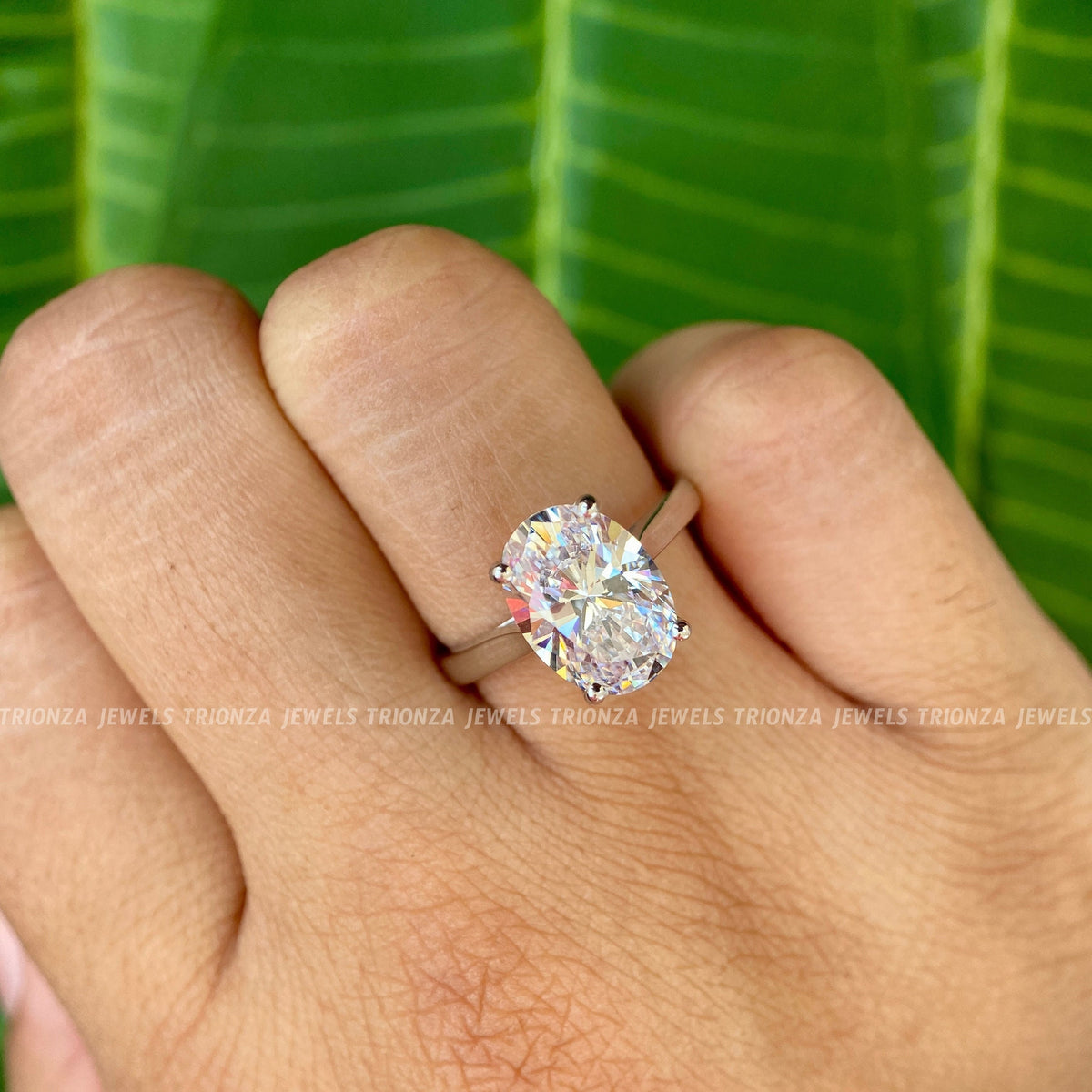 Close-up of the prong set oval moissanite highlighting its 3 CT weight and brilliance