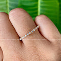 Close-up of the 1.50 mm colorless moissanite stones set in a minimalist band
