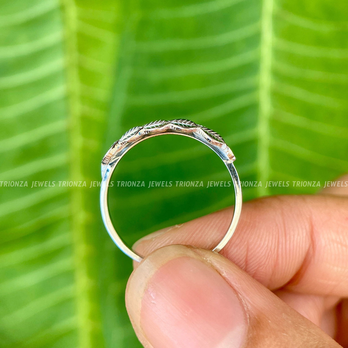 Leaf engraved eternity band displayed to highlight its organic straight band style