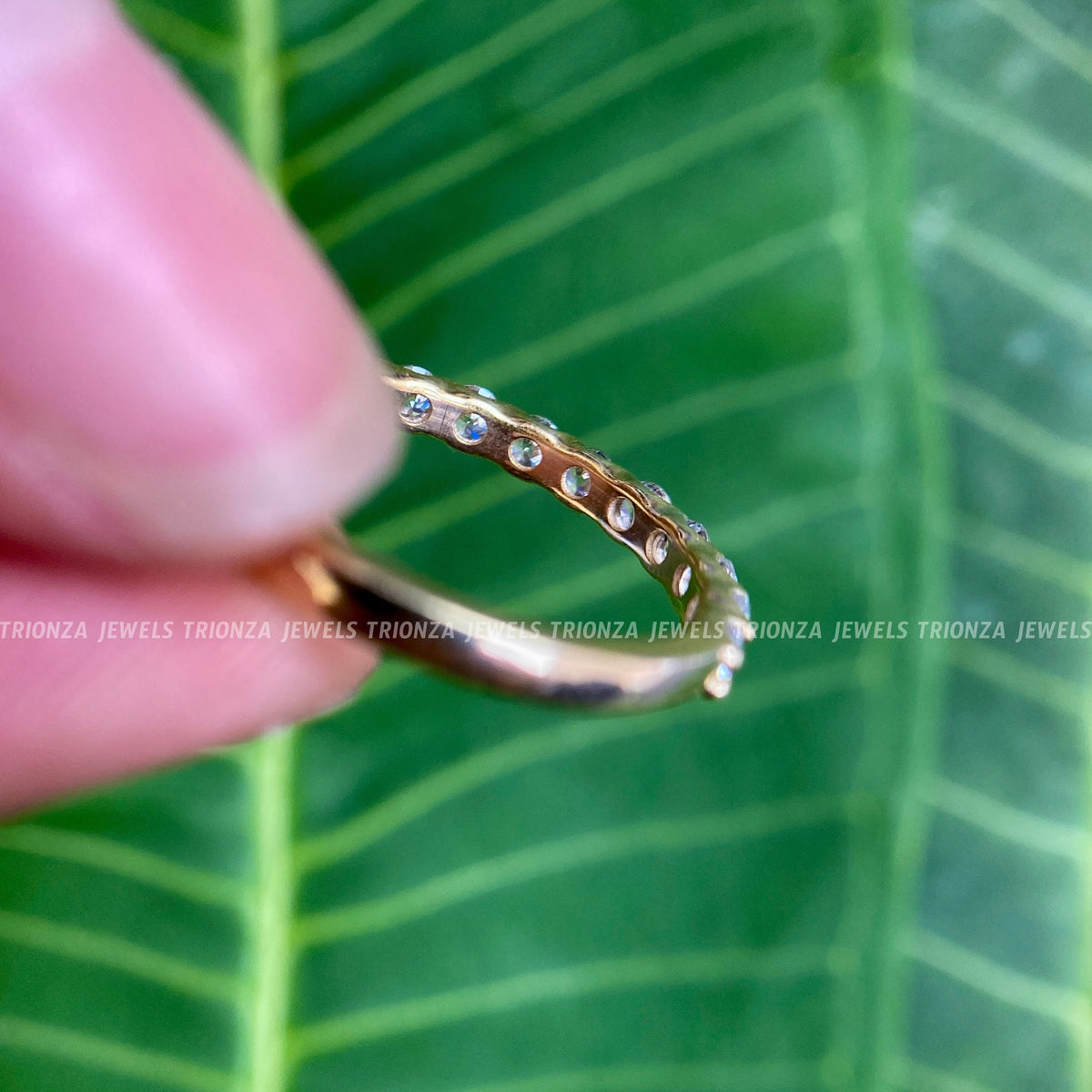 Woman wearing the 14k gold half eternity band as a matching wedding ring