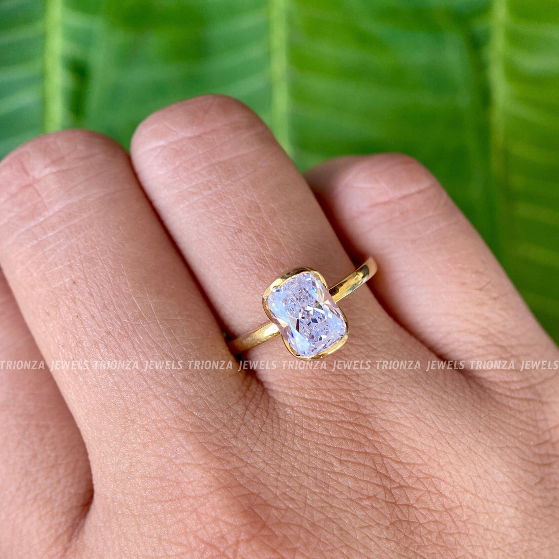 Cushion cut moissanite engagement ring displayed in a jewelry box with smooth fabric