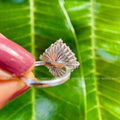 Close-up of the 3 CT round moissanite center stone surrounded by baguette accents
