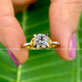 Woman wearing the round solitaire moissanite ring on her hand for a natural look