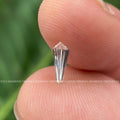 White shield cut diamond photographed from an angle to show its fancy cut outline