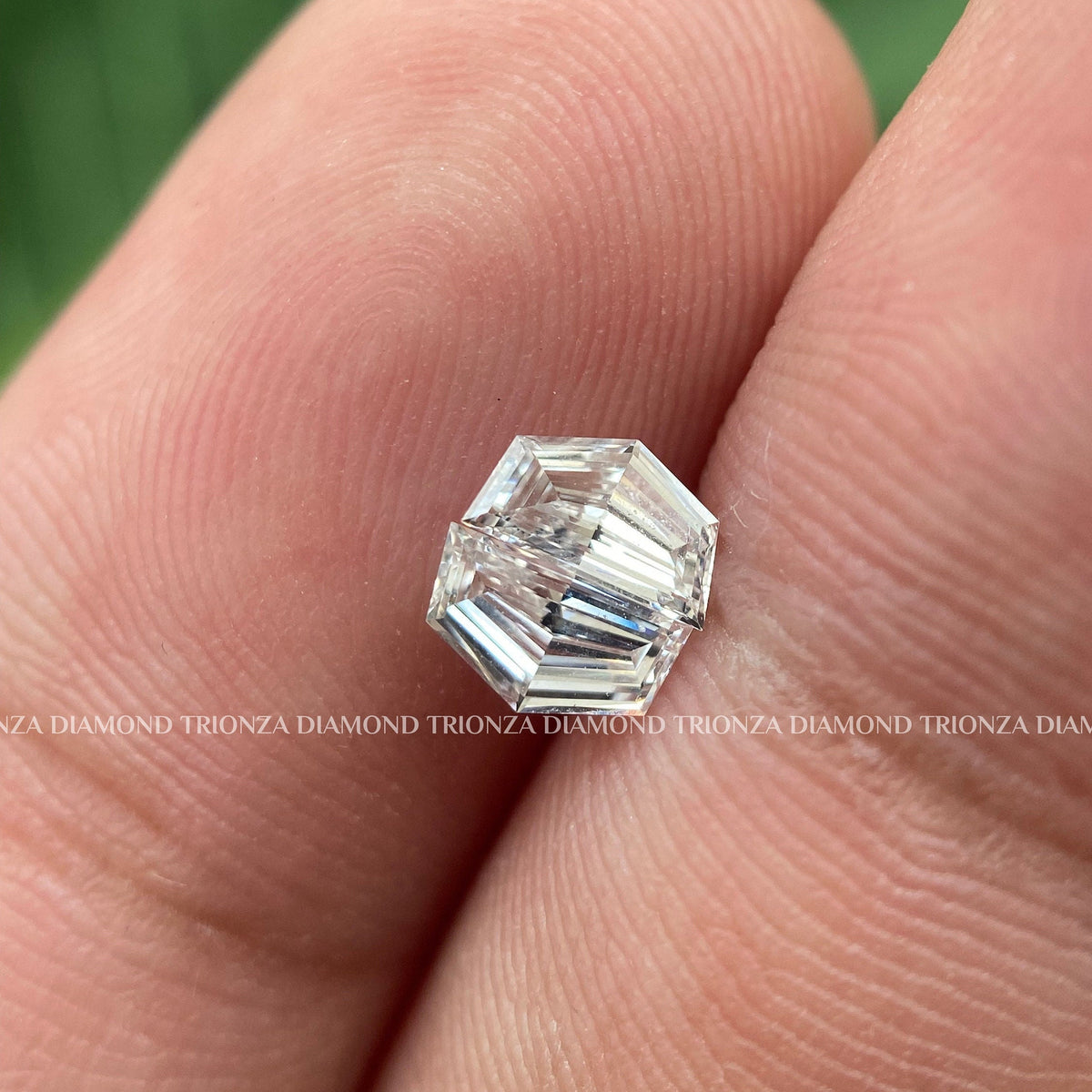 Cadillac step cut lab grown diamond pair displayed for side stone engagement ring settings