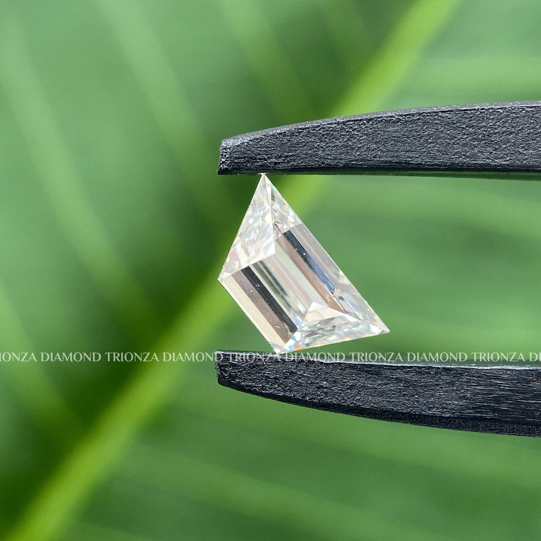 Trapezoid cut lab grown diamond displayed to show its brilliant faceted surface and clarity