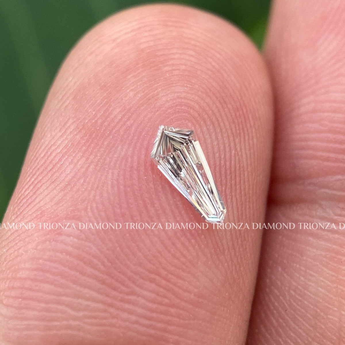 Loose shield shape diamond positioned to show brilliance ideal for an engagement ring