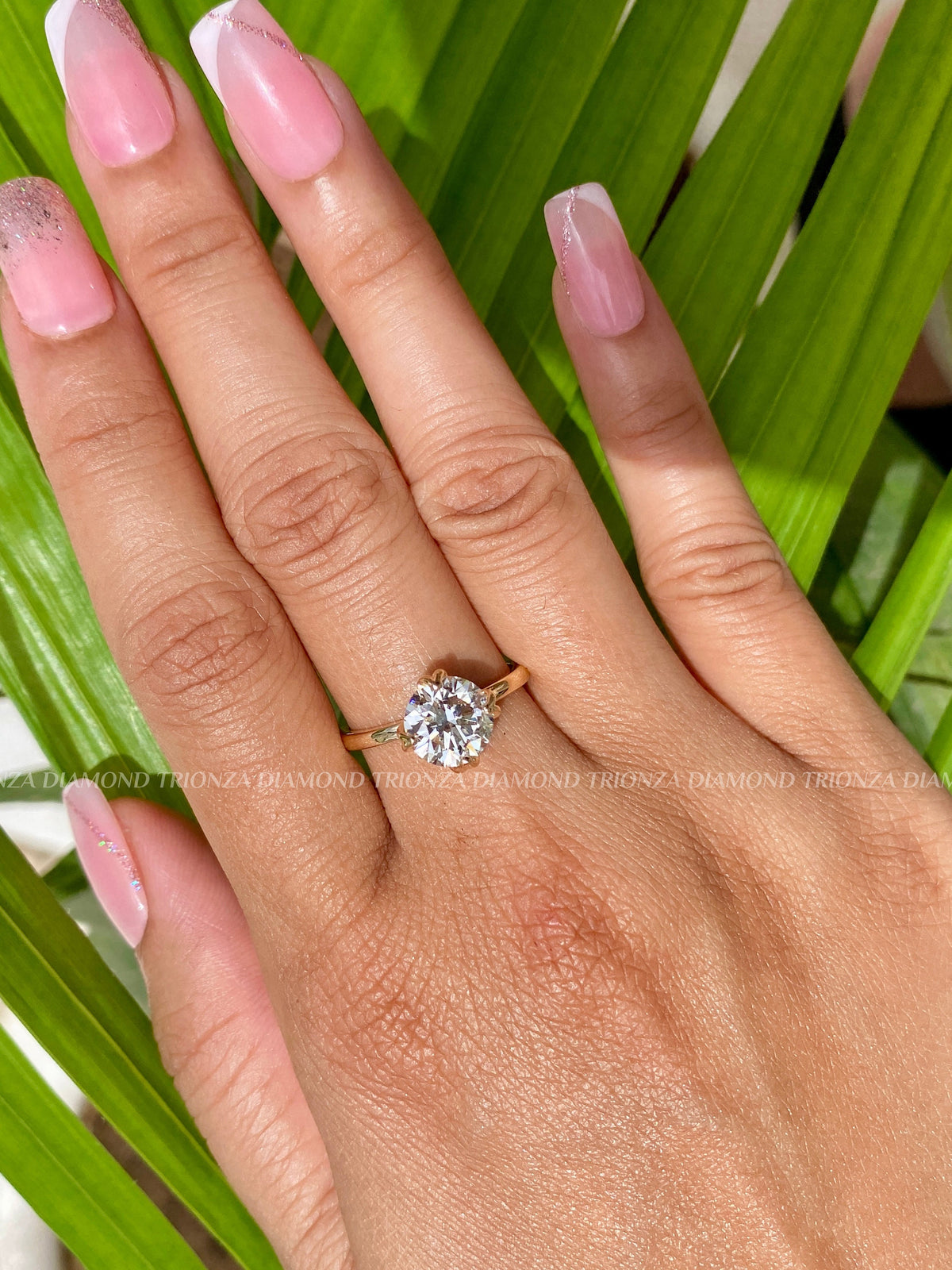 Side view of the floral prong setting holding the 2CT round diamond securely