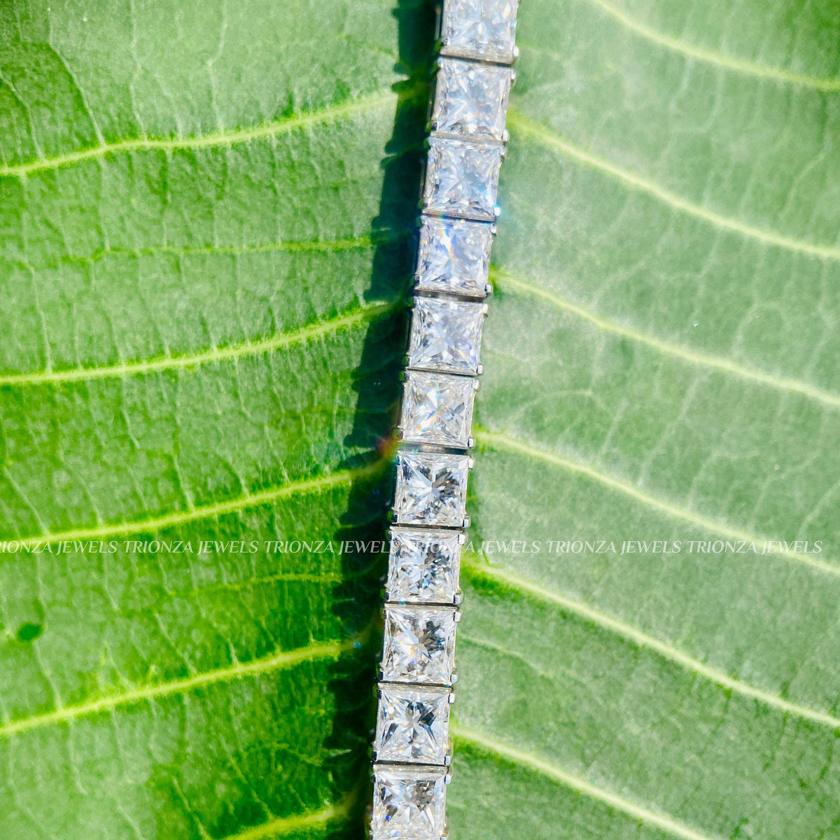 Woman wearing the stackable princess cut diamond tennis bracelet on her wrist