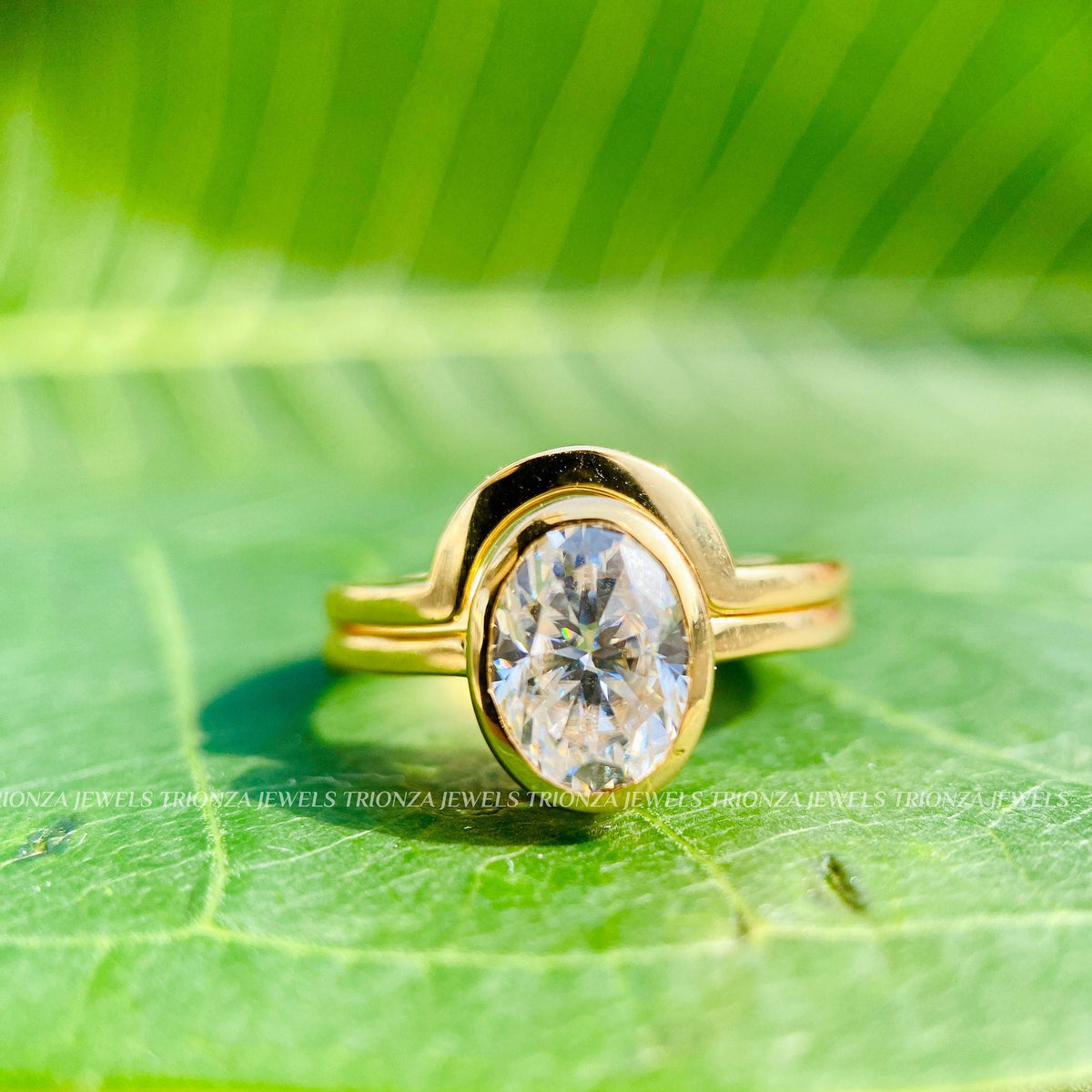 Oval cut diamond bridal set shown from above to reveal the bezel setting details
