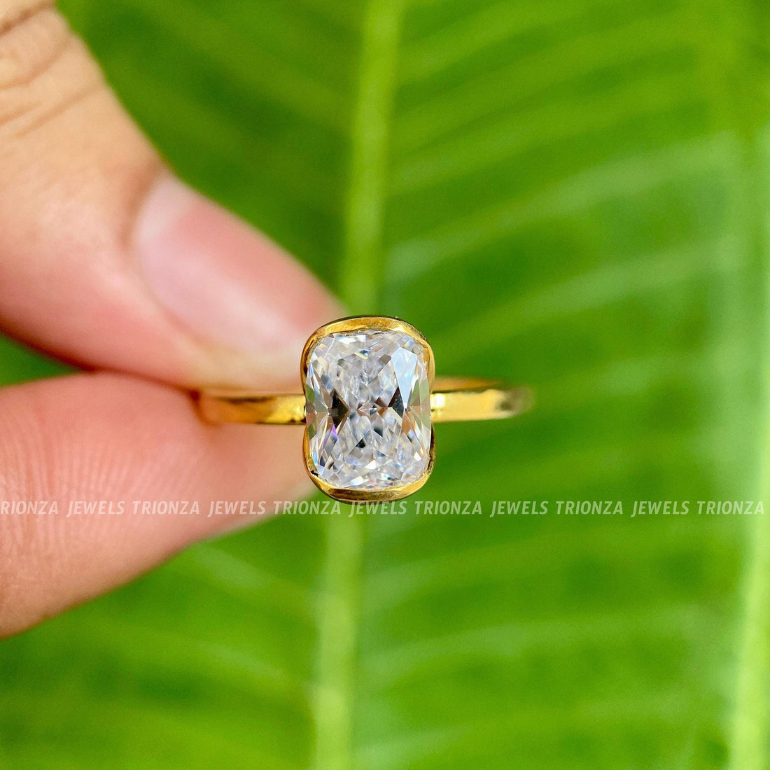 Cushion cut moissanite engagement ring displayed in a jewelry box with smooth fabric