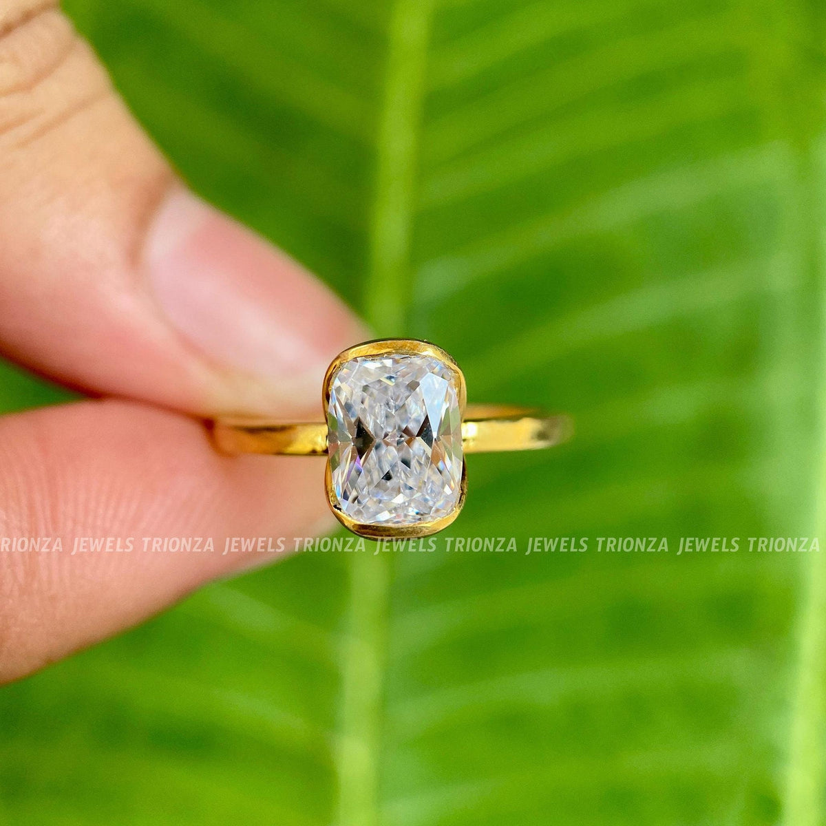 Cushion cut moissanite engagement ring displayed in a jewelry box with smooth fabric