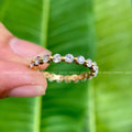 Full eternity round moissanite wedding band displayed to show its floating bubble design
