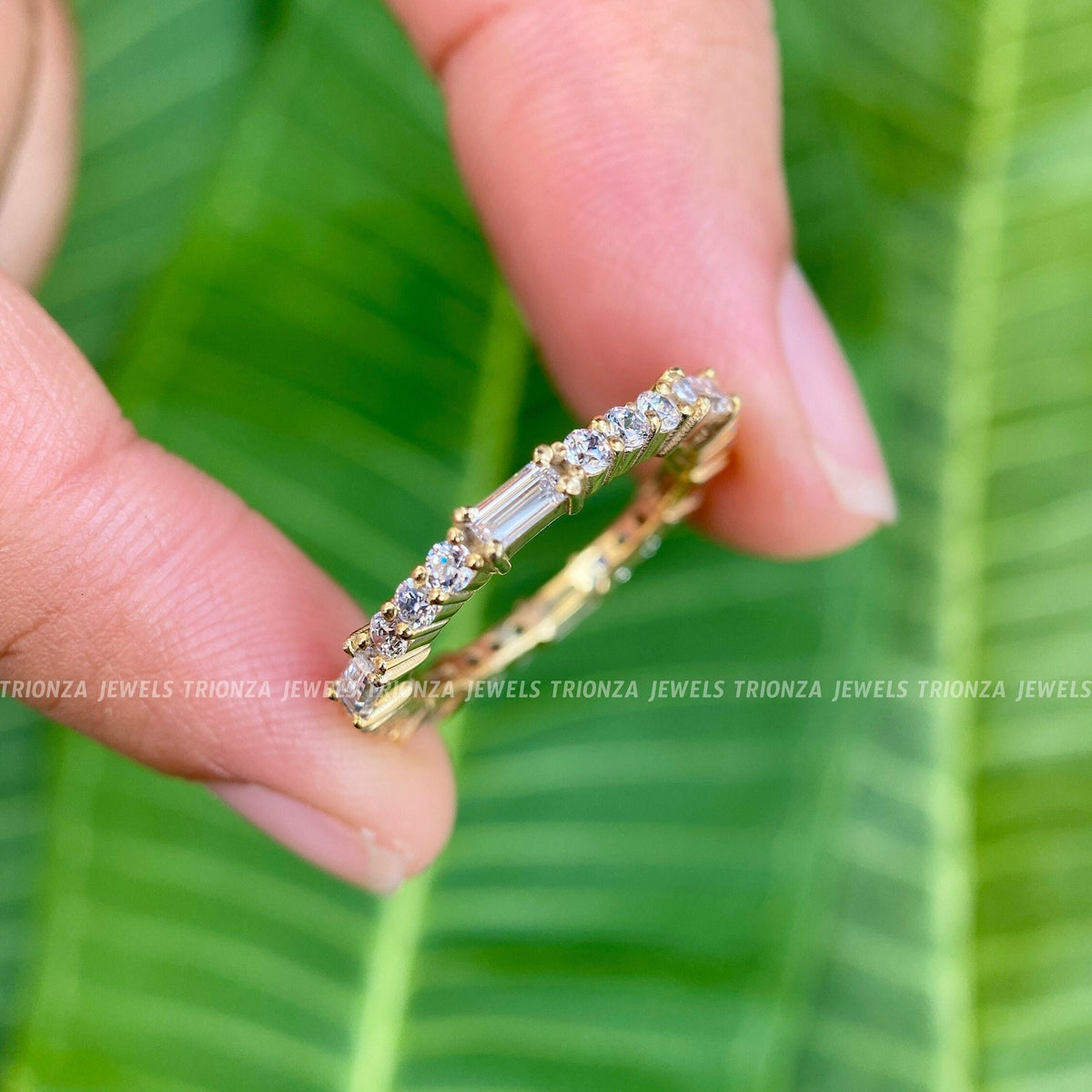 Full eternity wedding band featuring baguette and round cut moissanite set in solid gold