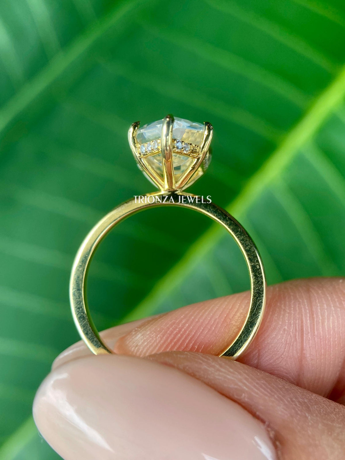 Colorless VVS moissanite solitaire ring shown from a side angle in yellow gold