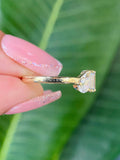 Close-up of the emerald cut and pear cut colorless moissanite stones set side by side
