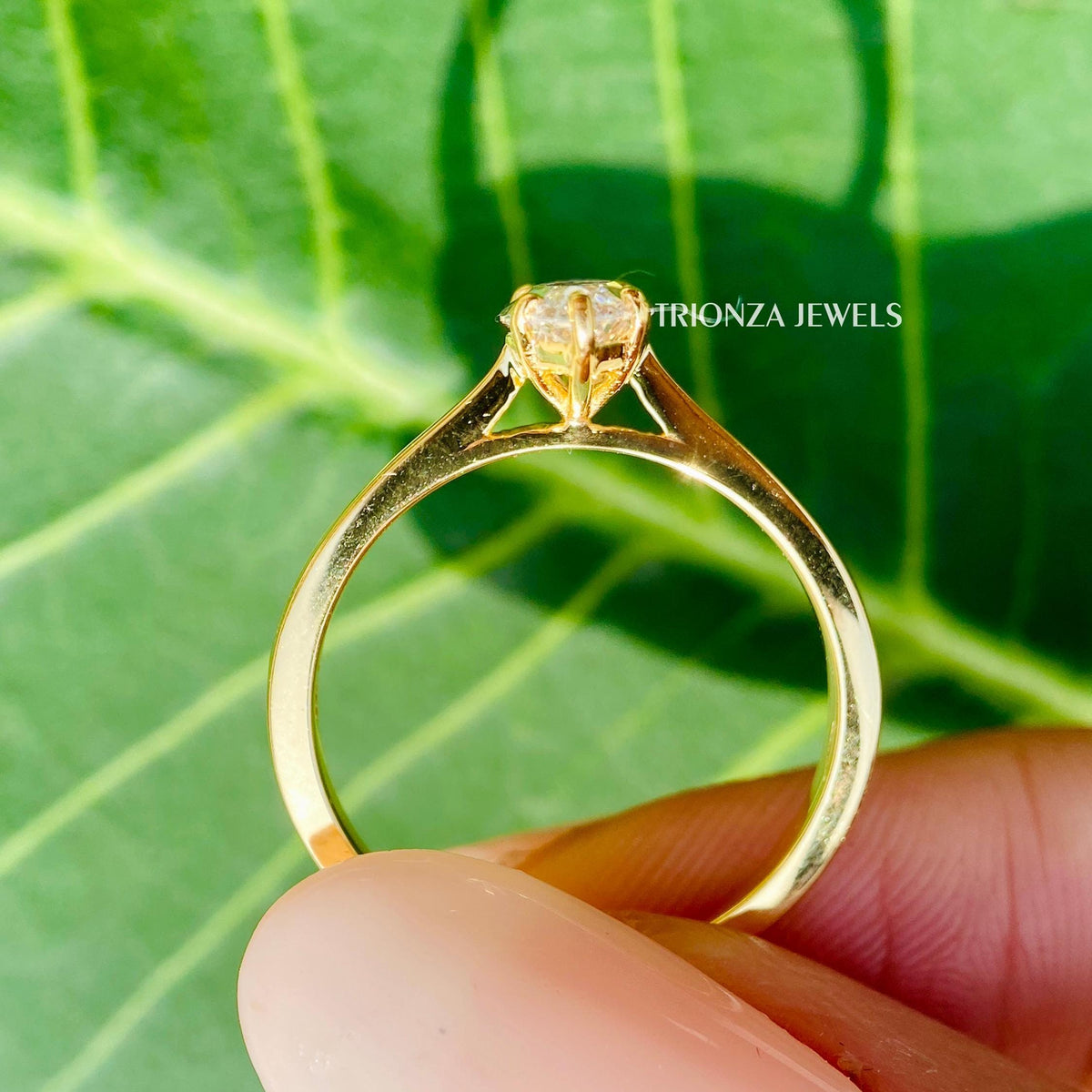 Cathedral setting engagement ring designed with prongs to secure the marquise moissanite stone