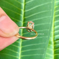 Close-up of the prong setting securing the elongated oval moissanite stone