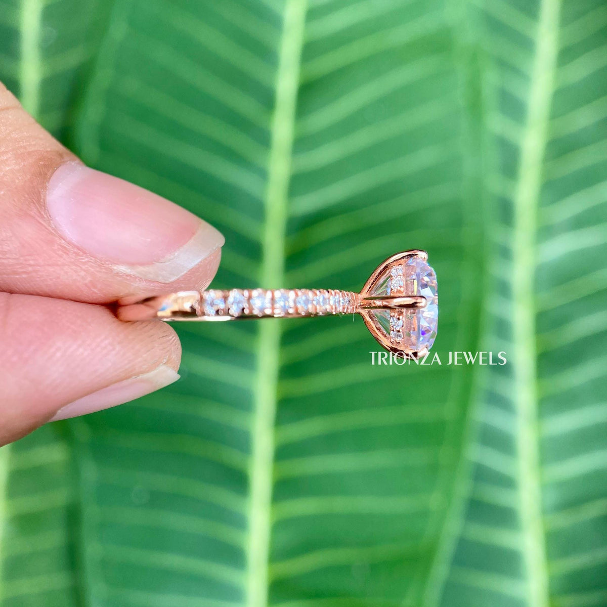 Close-up of the 6 claw prong setting securing the round moissanite stone