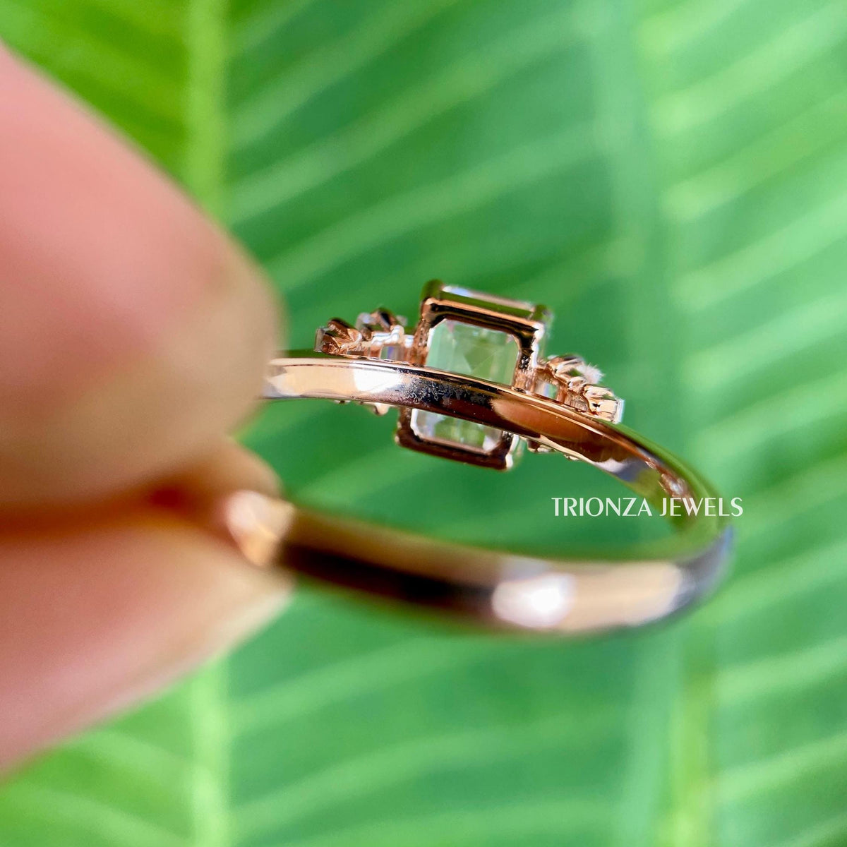 Woman wearing the emerald cut moissanite ring as a unique anniversary gift for her