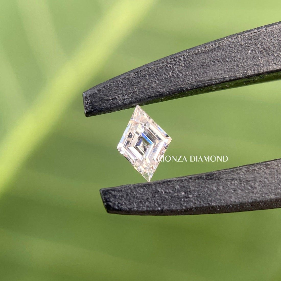Lozenge cut lab grown diamond displayed to showcase its antique cut faceting and brilliance