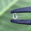 Oval step cut diamond positioned to display its brilliance and unique cut pattern