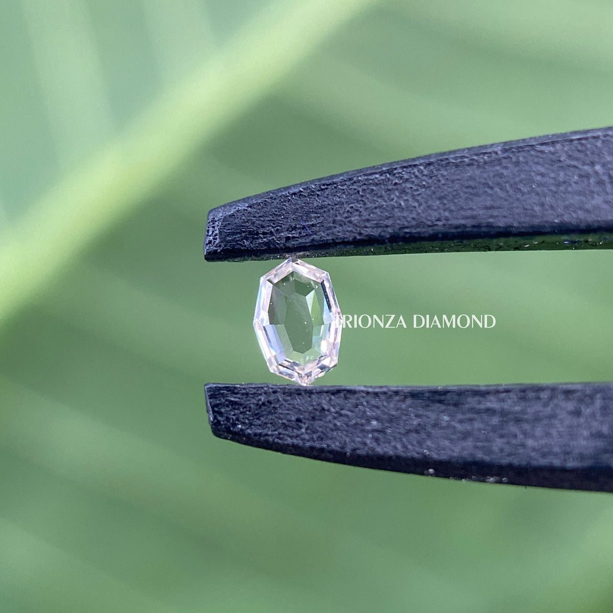 Oval step cut diamond positioned to display its brilliance and unique cut pattern